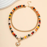 Multi layer gold-tone necklace with resin beaded pendant