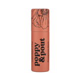 Lip balm container with 'Poppy & Pout' branding on a green background