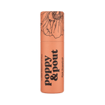 Lip balm container with floral design and text on a green background