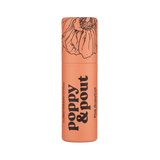 Lip balm container with floral design and text on a green background