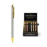 An Olivia Moss Glitter Bomb pen filled with floating glitter
