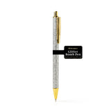 An Olivia Moss Glitter Bomb pen filled with floating glitter