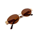 Oval sunglasses with a gold frame and brown lenses