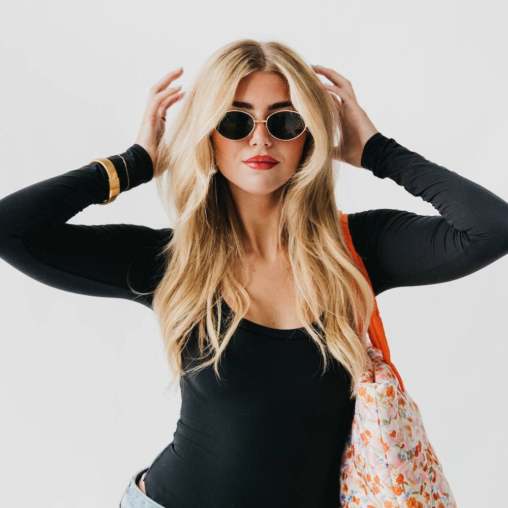 Oval sunglasses with a gold frame and brown lenses