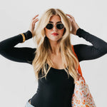 Oval sunglasses with a gold frame and brown lenses