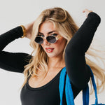 Oval sunglasses with a gold frame and brown lenses