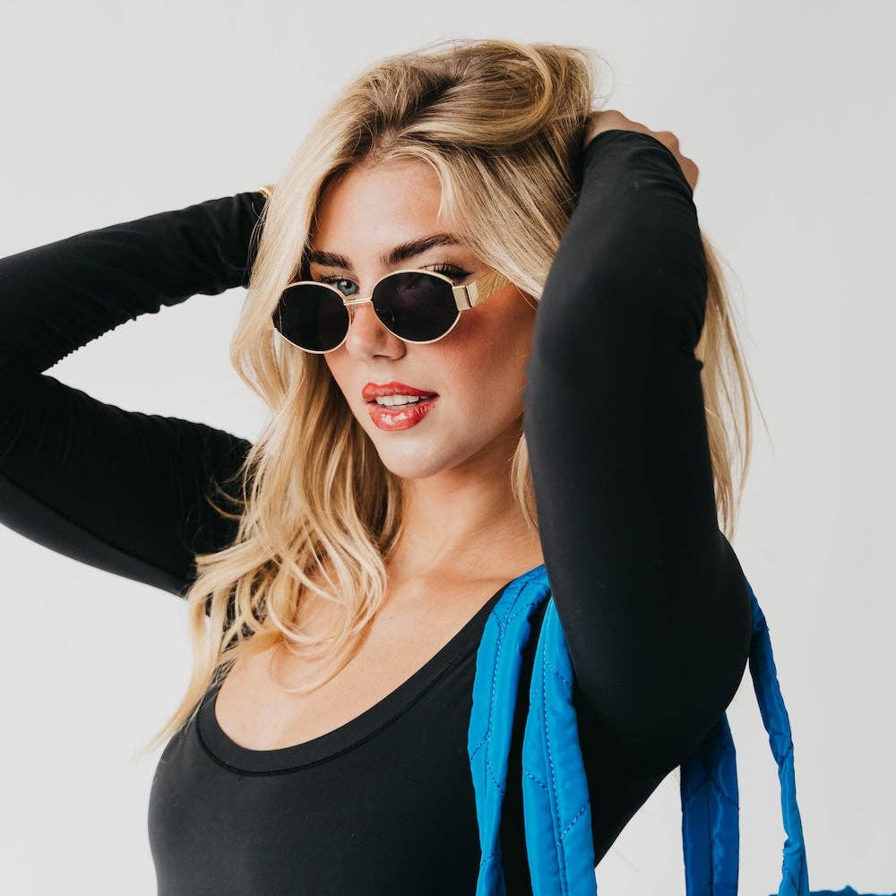 Oval sunglasses with a gold frame and brown lenses