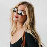 Oval sunglasses with a gold frame and brown lenses