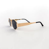 Oval sunglasses with a gold frame and brown lenses