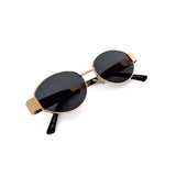 Oval sunglasses with a gold frame and brown lenses