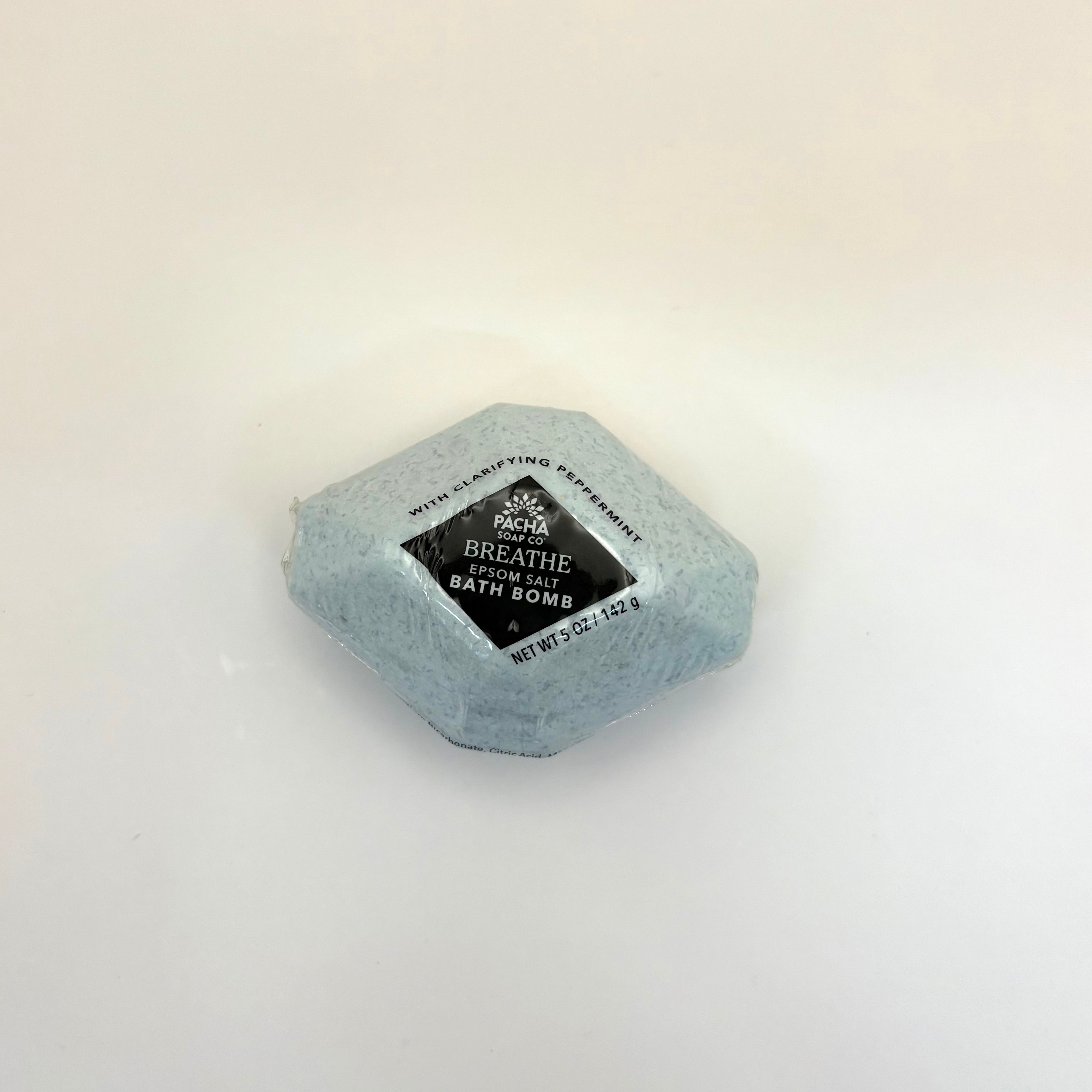 Pacha soap co breathe epsom salt bath bomb with a label on a light beige background