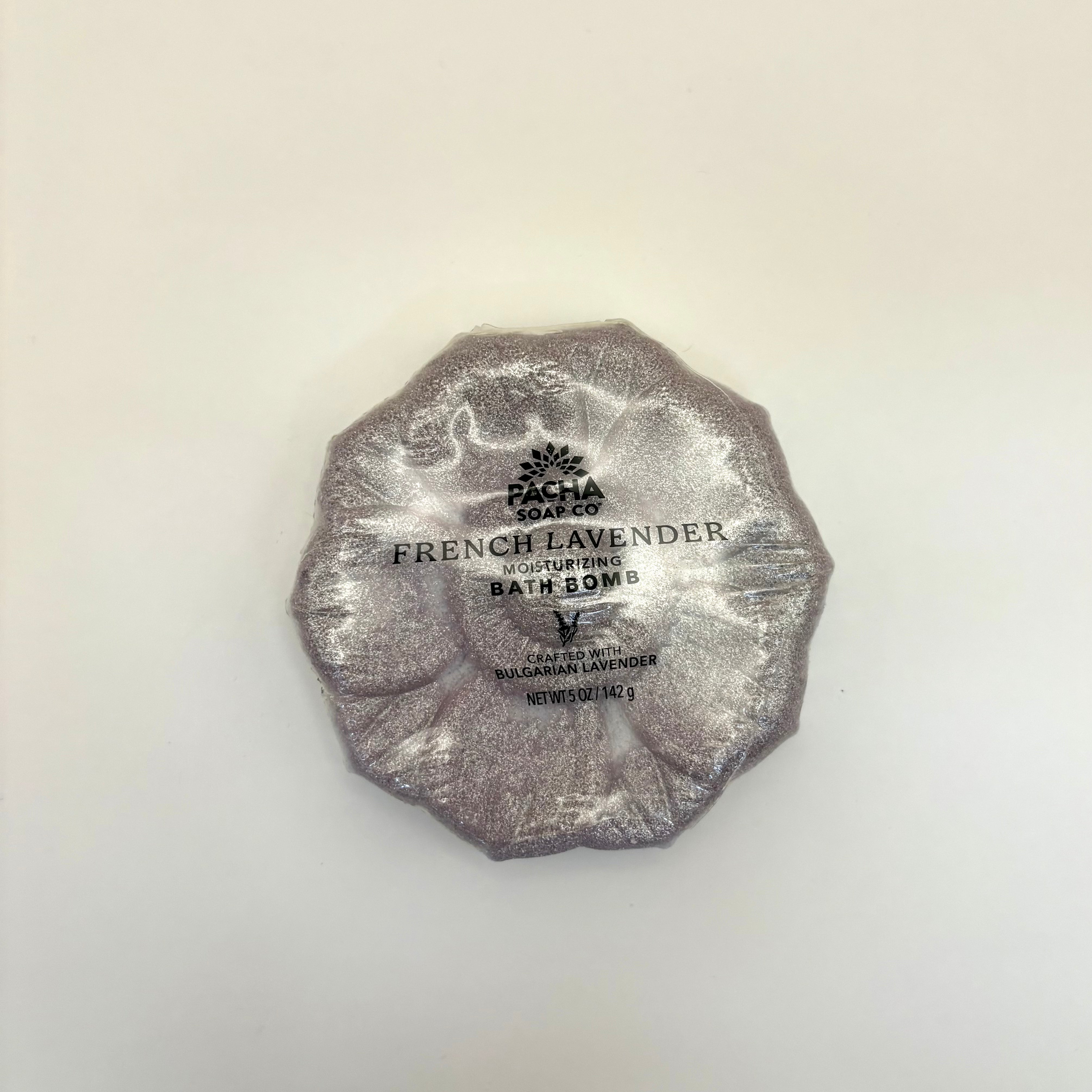 French Lavender bath bomb wrapped in silver foil on a light beige background