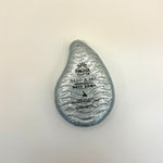 Sand and sea bath bomb with 'Pacha Soap Co' branding on a light background