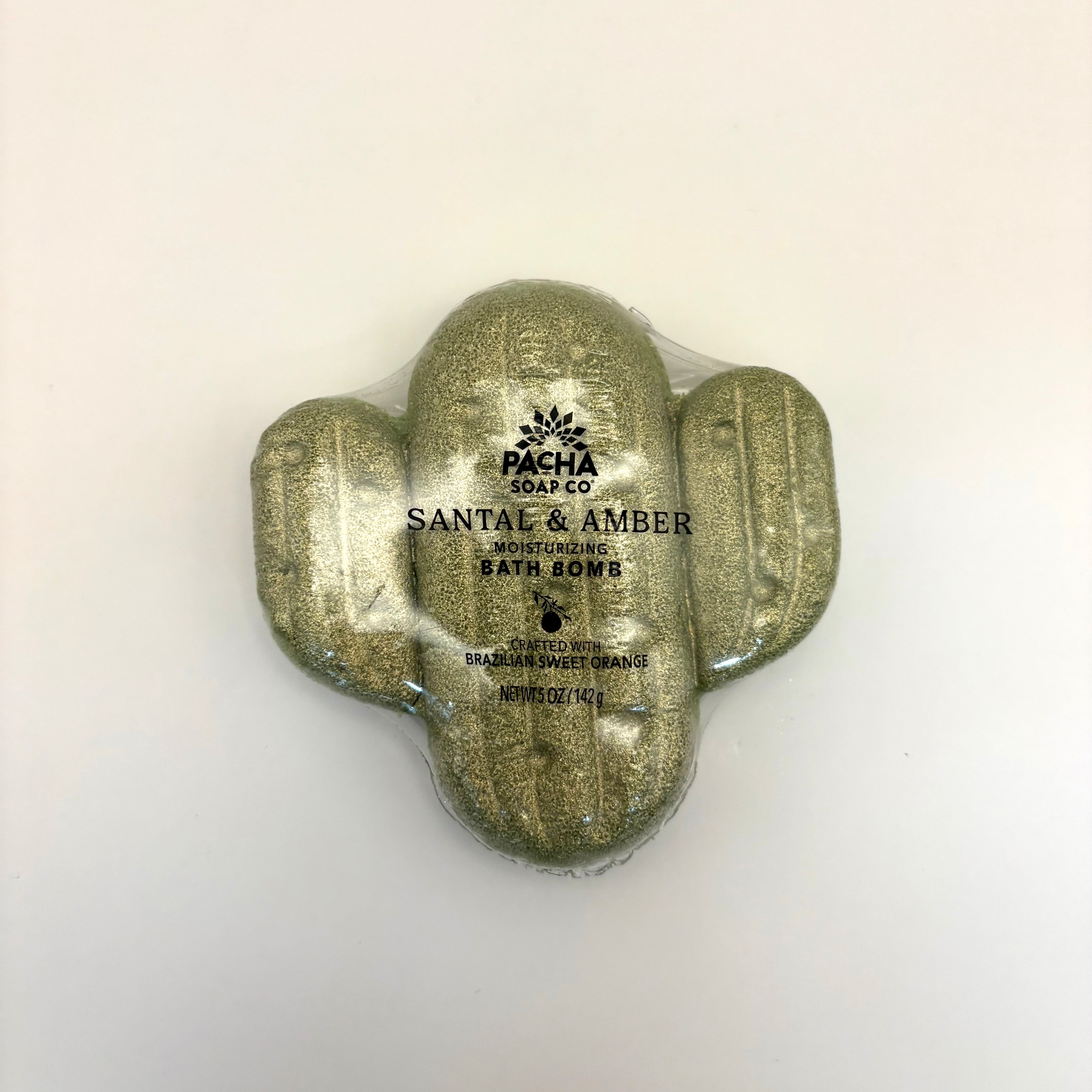 Cactus santal and amber bath bomb with 'Pacha Soap Co' branding on a beige background