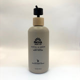 Santal and amber body lotion bottle with wooden cap on a white background