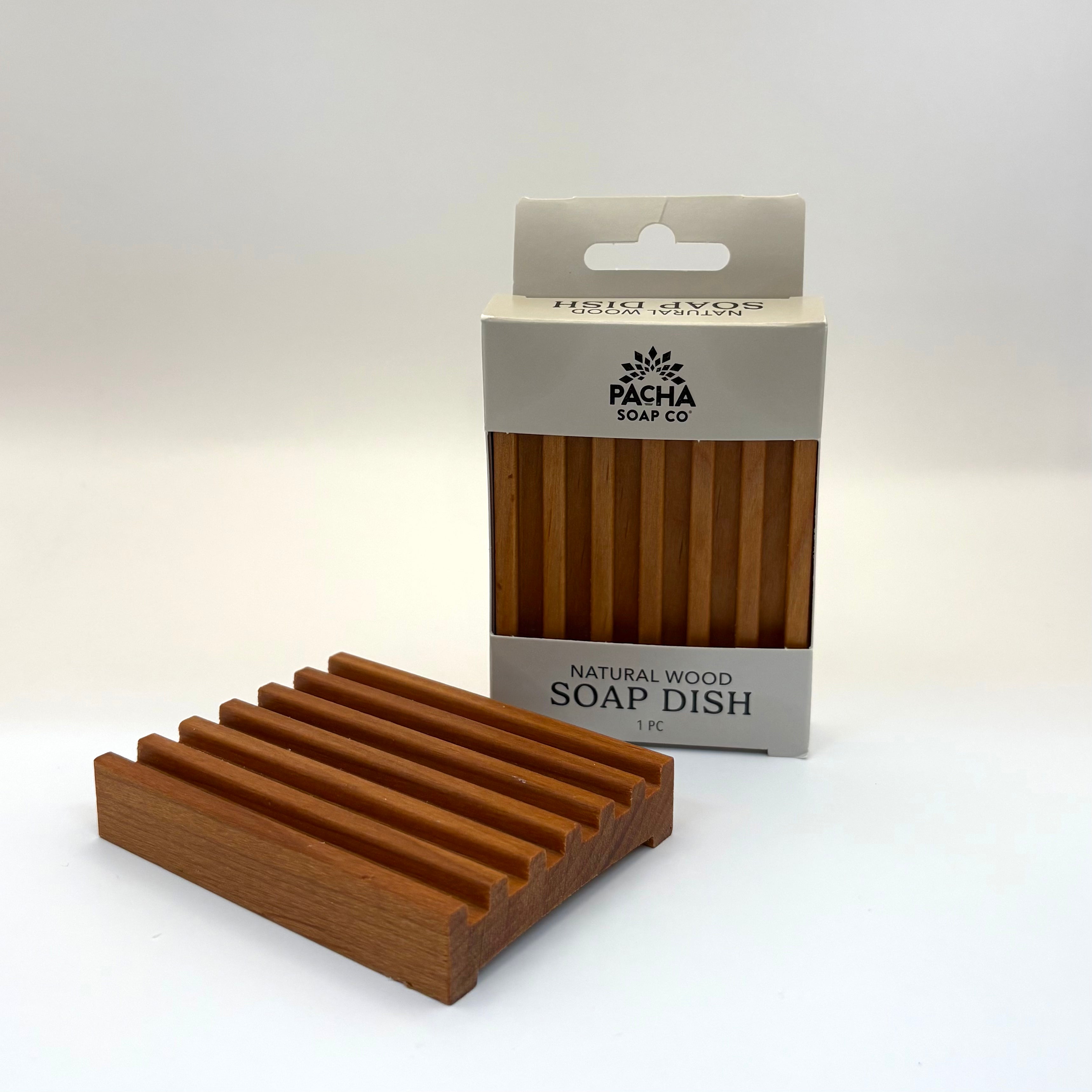 Wooden soap dish with Pacha Soap Co packaging on a white background