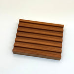 Wooden pacha soap co tray panel with a ribbed design on a white background