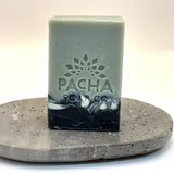 Bar of vanilla and sage soap with 'Pacha Soap Co' logo on a stone surface