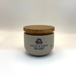 Jar of Pacha Soap Co Santal & Amber Gentle Cleansing Body Scrub with wooden lid on a white background