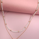 Double layer pearl and gold chain necklace with bean charm