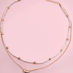 Double layer pearl and gold chain necklace with bean charm