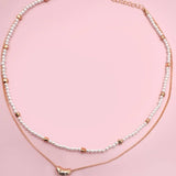 Double layer pearl and gold chain necklace with bean charm
