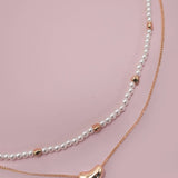 Double layer pearl and gold chain necklace with bean charm