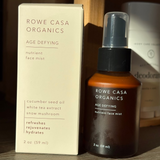 Rowe Casa Organics nutrient face mist bottle and packaging on a wooden surface
