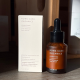 Rowe Casa Organics skincare product and packaging on a wooden surface