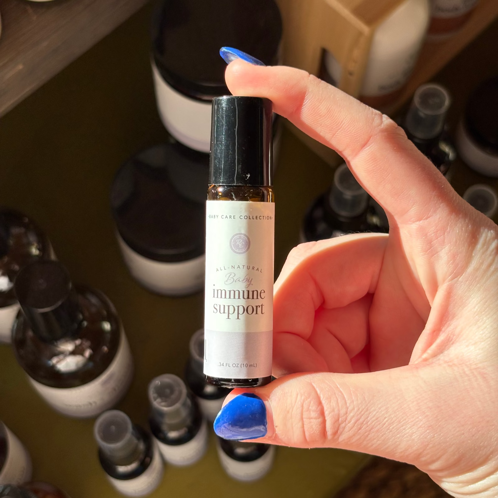 Hand holding a bottle labeled Rowe Casa immune Support in front of shelves with various other bottles.