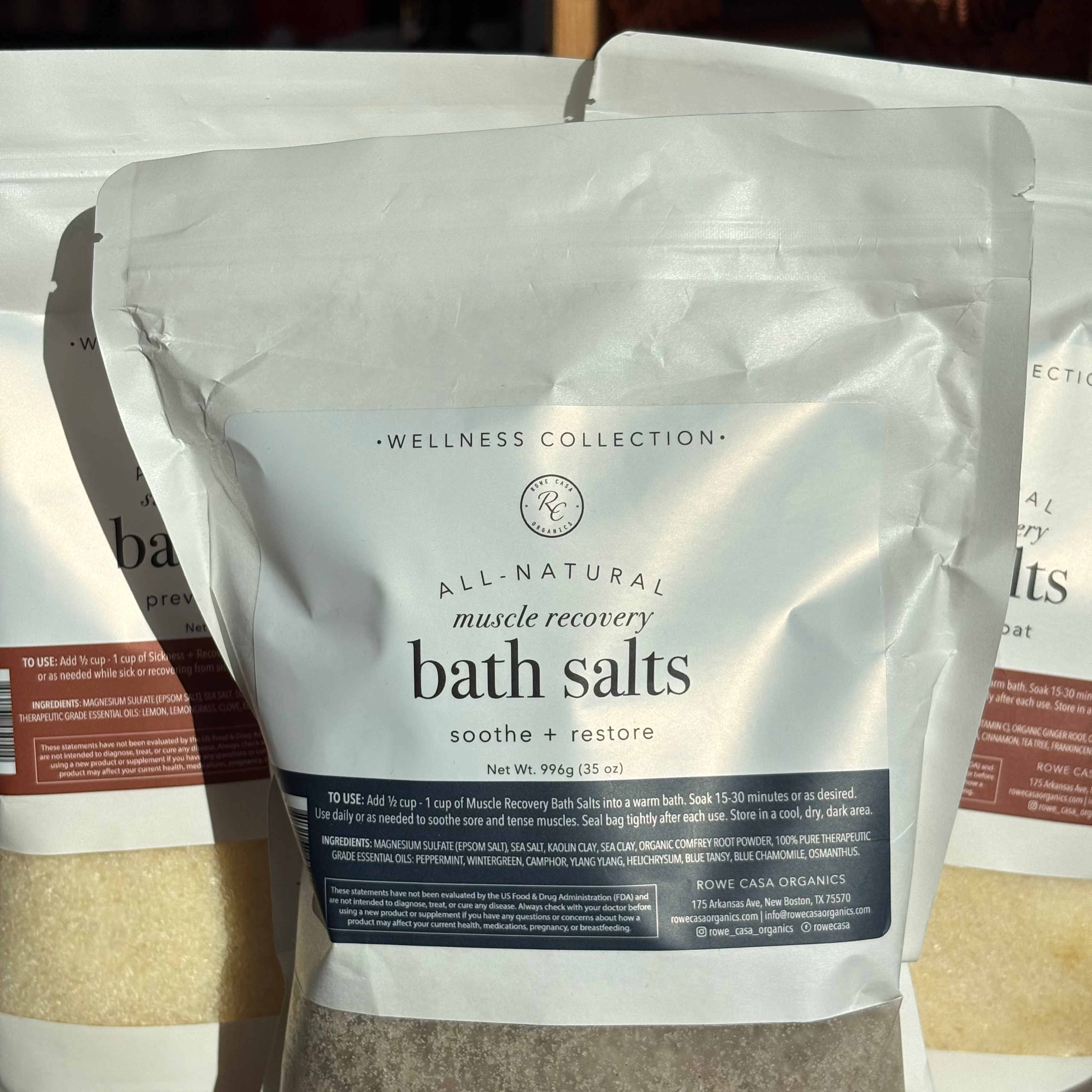Package of All-Natural Muscle Recovery Bath Salts from Wellness Collection on a wooden surface.