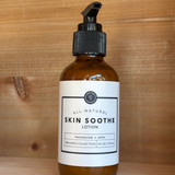Bottle of Rowe Casa 'Skin Soothe' lotion on a wooden surface