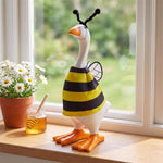 Table-sized goose figurine dressed in a mini outfit