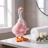 Table-sized goose figurine dressed in a mini outfit