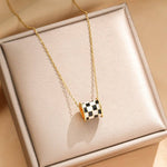 Tarnish-free stainless steel barrel necklace with checkered enamel pendant