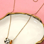 Tarnish-free stainless steel barrel necklace with checkered enamel pendant