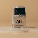 Bottle of Aura House Diffuser Cleaner, sized to screw directly into the Aura Scent Diffuser