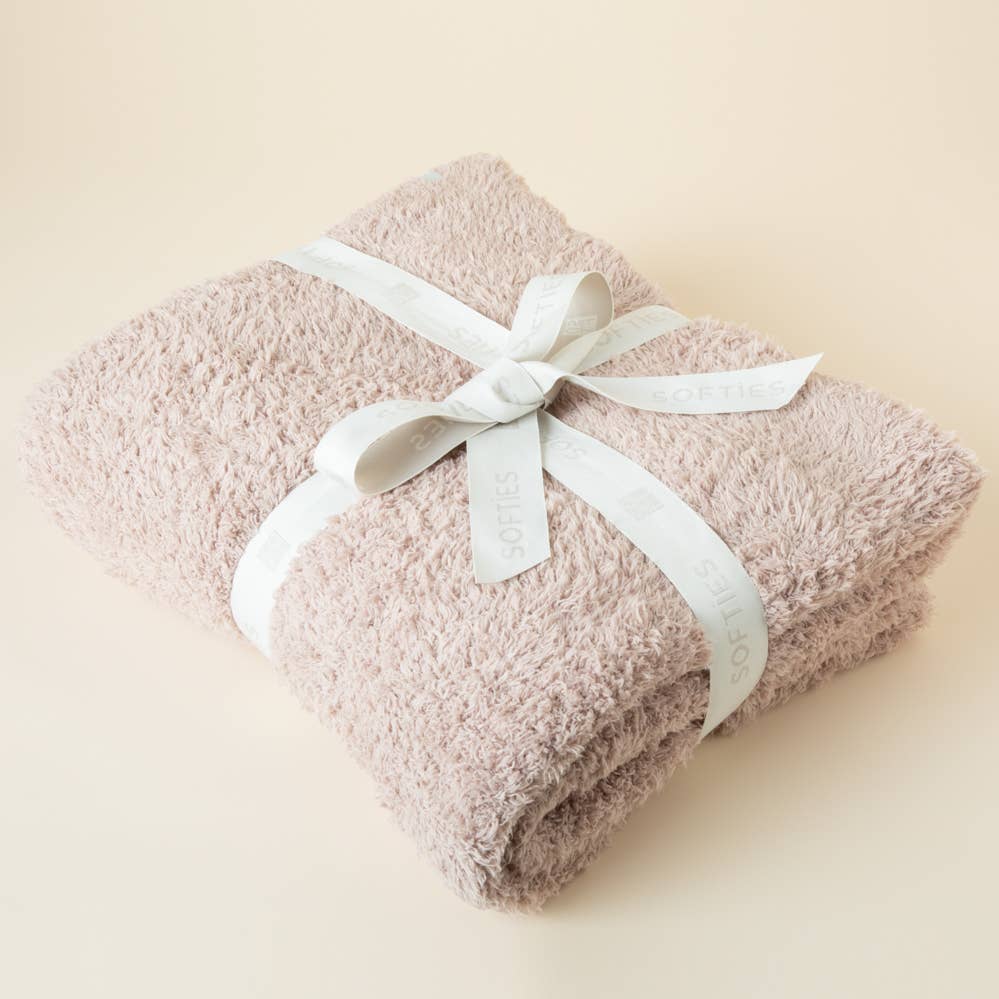 Lightweight plush throw blanket draped over a couch