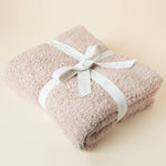 Lightweight plush throw blanket draped over a couch