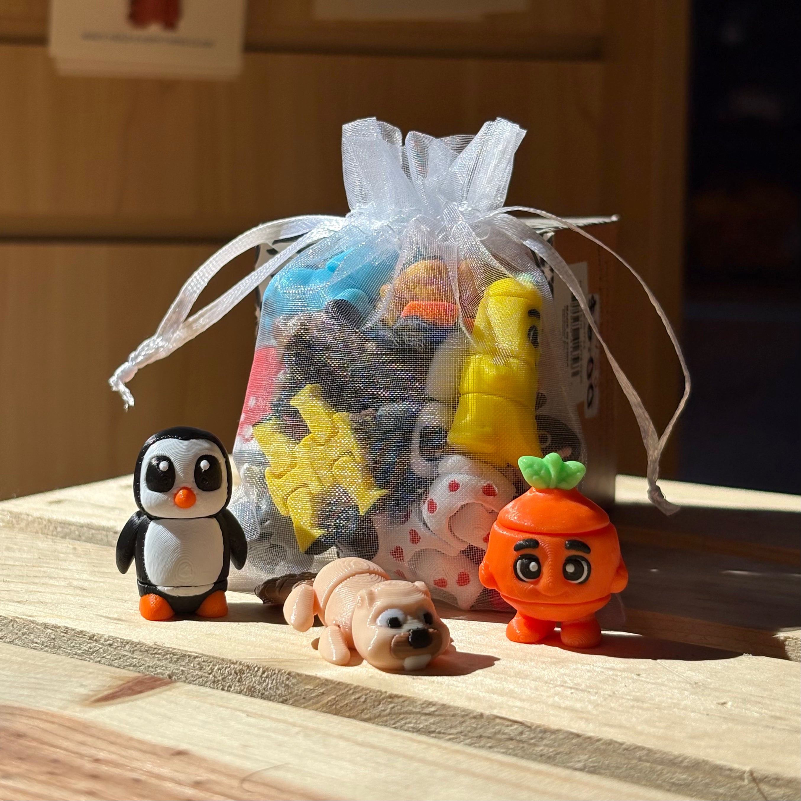 Wigglitz toys on a crate with a bag filled of toys and a display of a beaver, carrot, and a beaver