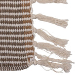 Close-up of the woven stripe pattern and fringe on the cotton blend throw
